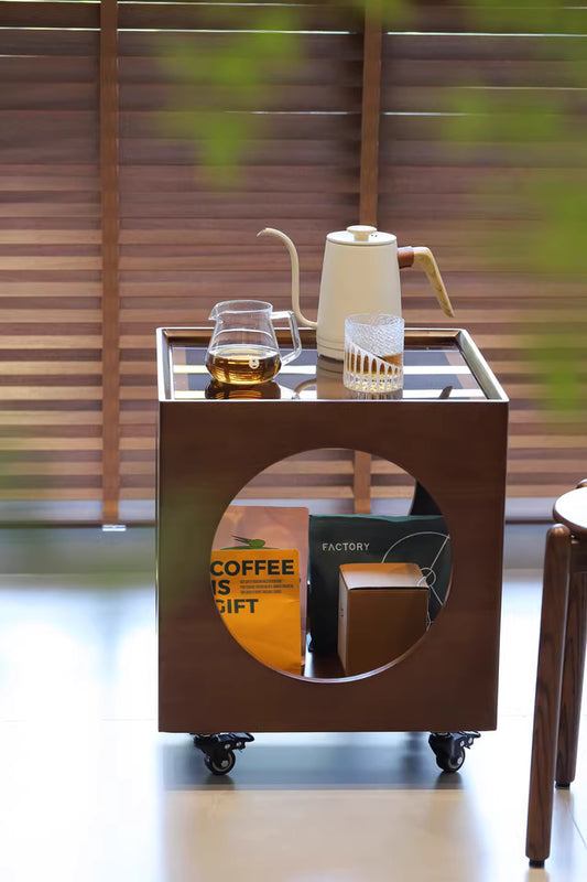 Space-saving cube side table with tempered glass top and smooth-glide casters for studio living
